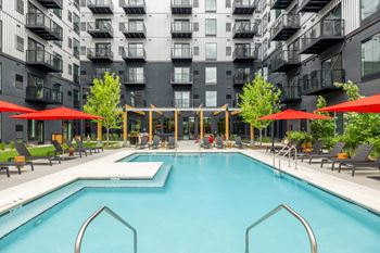 a swimming pool in front of an apartment building